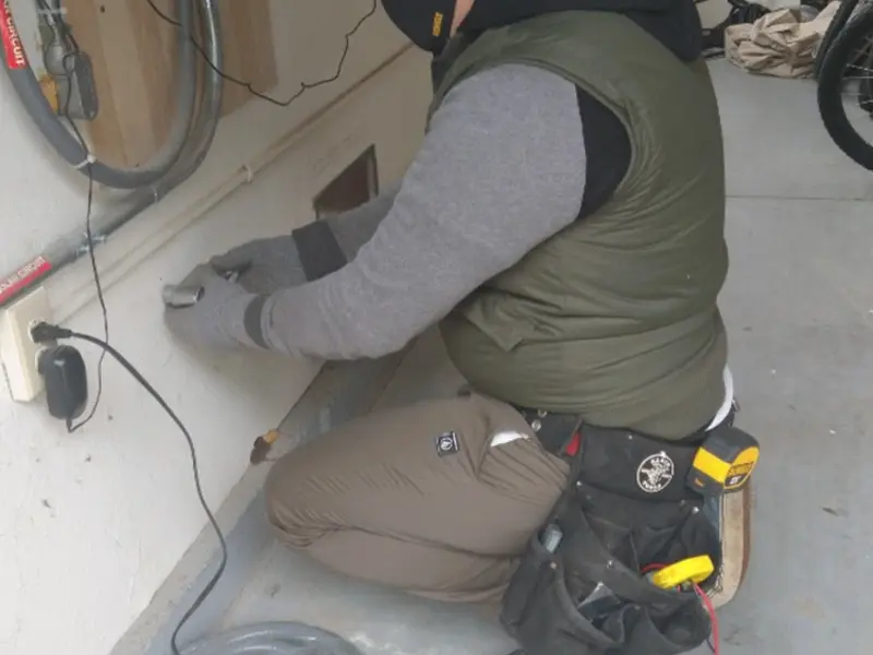 Electrician performing outlet wiring in a Martinsburg garage